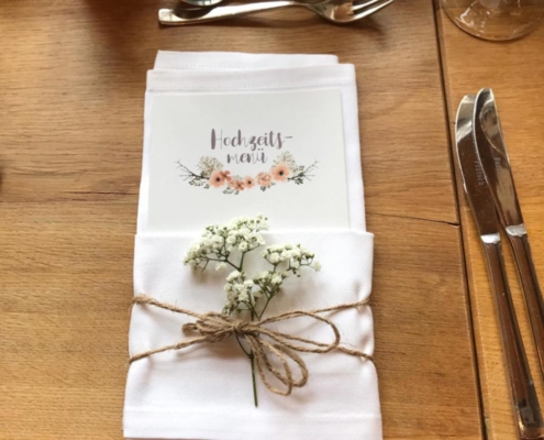 Mit Blumen dekorierte Menükarten für eine Hochzeit.